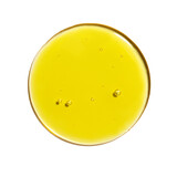 Drop of yellow oil swatch texture in petri dish macro with bubbles, cosmetics for face and body, science, laboratory isolated on white background