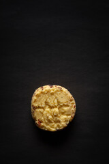 Wall Mural - One whole wheat chip cookie on a black background. Top-down view. Food Flat lay.