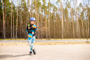 Wall Mural - happy child schoolboy hugging his bright plastic city cruiser, skateboard. in the park.