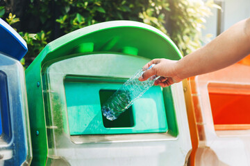 Wall Mural - people hand holding garbage bottle plastic  putting into recycle bin for cleaning