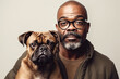 © Trinette Reed - Studio portrait of mature black man with his boxer puppy dog.  Generative AI.