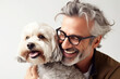 © Trinette Reed - Studio portrait of mature man smiling cuddling his pet dog smiling.  Generative AI.