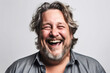 © Trinette Reed - Studio portrait of mature man laughing in studio on white background. Generative AI.