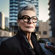 © TRINETTE + CHRIS - Portrait of senior mature woman CEO businesswoman in city outdoors. Generative AI.