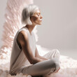 © Trinette Reed - Calm woman sitting meditating in white spiritual looking room. Generative AI.