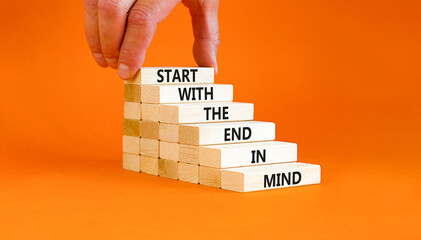 Wall Mural - Start in end of mind symbol. Concept words Start with the end in mind on wooden blocks. Beautiful orange table orange background. Businessman hand. Business start in end of mind concept. Copy space.