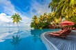 © icemanphotos - Stunning landscape, swimming pool blue sky with clouds. Tropical resort hotel in Maldives. Fantastic relax and peaceful vibes, chairs, loungers under umbrella and palm leaves. Luxury travel vacation