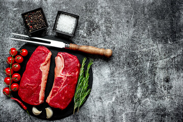 Wall Mural - raw beef steak on stone background with copy space for your text