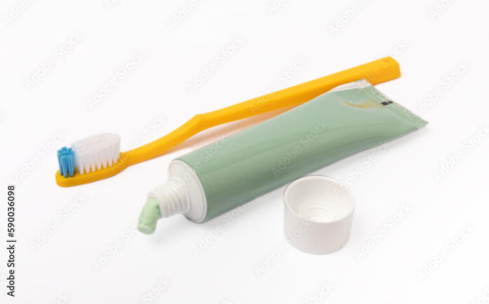 Tube of toothpaste and toothbrush isolated on white background. Close ...