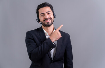 male call center operator wearing headset and formal suit finger pointing at customizable empty spac