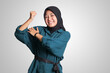 © Yazid Nasuha - Portrait of excited Asian muslim woman with hijab showing strong biceps, demonstrating strength. Isolated image on white background