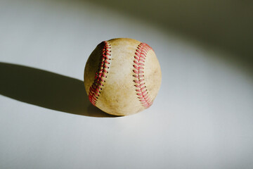 Wall Mural - Old rough texture of used baseball alone with shadow in spotlight for sport.