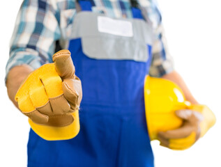 Wall Mural - Worker man with helmet pointing at you on background