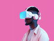 © Michael - Amazed excited young african american man, wearing white high tech smart vr goggles, watching 360 degree video 0ver pink background, Generative AI