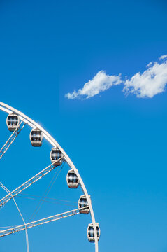 part of ferris wheel against a blue sky background. ferris wheel with cabins in a minimalist style. 