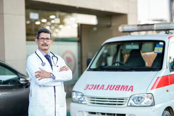 Wall Mural - Confident indian male doctor standing at hospital