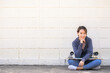 © interstid - Happy smilling Asian woman relax sitting oustside with skateboard on lap