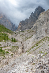 Sticker - Hikers on a trail in a mountainous barren landscape