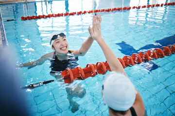 Swimming pool, sports and women high five in water for teamwork, collaboration or solidarity. Swimmer, happiness and friends or girls with hand gesture for support, success and celebration at workout