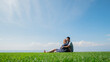 © StockMediaSeller - Asian man with a pregnant woman are resting in nature in a picturesque place, sit on the green grass