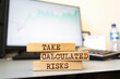 © Uuganbayar - Wooden blocks with words 'Take Calculated Risks'. Business concept