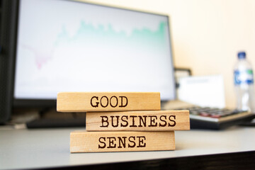 Poster - Wooden blocks with words 'GOOD BUSINESS SENSE'. Business concept