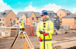 © Iryna - Surveyor builder site engineer with theodolite total station at construction site outdoors during surveying work