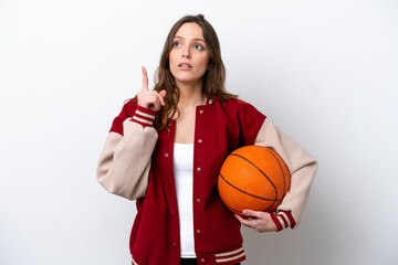 Wall Mural - Young caucasian woman playing basketball isolated on white background thinking an idea pointing the finger up