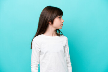 Sticker - Little caucasian girl isolated on blue background looking to the side