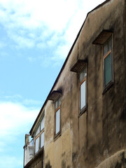 Wall Mural - exterior of old home in street with blue sky