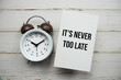 © may1985 - It's never too late text message with alarm clock top view on wooden background