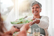 © C. Daniels/peopleimages.com - Family dinner, senior woman and healthy salad of a happy female with food in a home. Celebration, together and people with unity from eating at table with happiness and a smile in a house giving meal