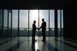 © Bruno - Silhouette of two businessmen men's silhouette shaking hands in a modern office with a view. Generative Ai
