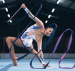 © M Dharsey/peopleimages.com - Portrait of flexible woman, ribbon gymnastics and dance for performance, sports competition and action show. Female, rhythmic movement and dancing athlete with creative talent, balance and agility