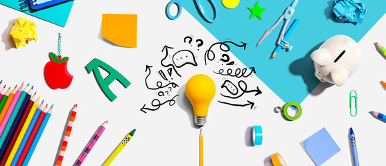 Wall Mural - Brainstorming concept with a light bulb and school supplies - Flat lay