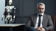 © Haydiddle - Mature man at a job interview wearing a suit. The older person is competing against an artificial intelligence robot for the same work. generative AI