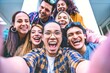 © Nicolas Micolani - Happy group of multiracial friends taking selfie shot outside on holiday- Young people taking photo looking at camera and having fun- Youth diversity and community concept with guys