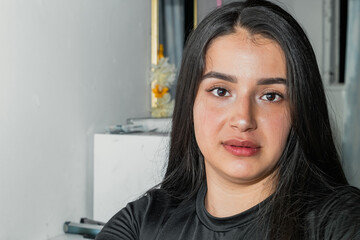 closeup of the face of a beautiful young latin woman looking straight ahead