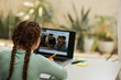 © DragonImages - Schoolgirl attending online class, view from back
