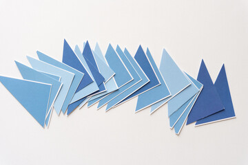 Wall Mural - set of layered blue triangles on blank paper