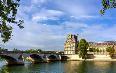 Wall Mural - Paris cityscape from Seine river. The bridge Pont Royal, Louvre and embankment.