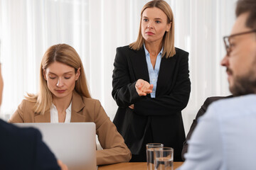 Canvas Print - Businesswoman having meeting with her employees in office