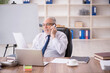 © Elnur - Old male employee working in the office