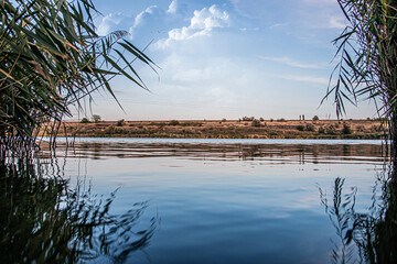 Wall Mural - Calm still water against a cloudy sky	
