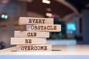Wooden blocks with words 'Every obstacle can be overcome'.