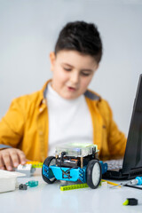 Wall Mural - robotics programming class. children construct and code robot. stem education using constructor bloc