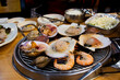 Gourmet food grilled roasted seafood and shell fried burn for korean people traveler travel visit and taste eat drinks cuisine in local restaurant at Hueundae Street Food​ Market in Busan, South Korea