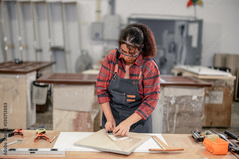 A Carpenter carefully measures, marks dimensions, and lays out ...