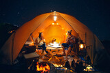 Fototapeta  - Asian couple enjoy in they tent in camping trip on night time