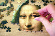 Jigsaw Puzzle Of Female Face Mona Liza La Gioconda from Leonardo Da Vinci, from ancient painting on wooden background